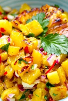 Delicious grilled pineapple salsa with fresh ingredients in a bowl.