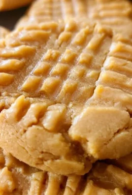 Thick and chewy peanut butter cookies on a baking tray
