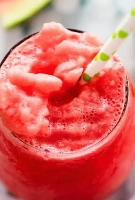 Delicious watermelon lemonade slushies in a colorful glass, perfect for summer.